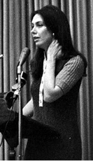 Joann Castle speaking into a microphone